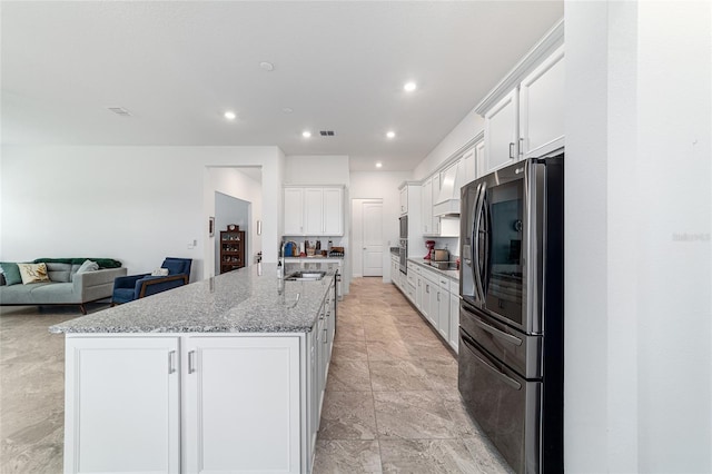 6046 SW 86th Cir, Ocala, FL 34481 - kitchen with stainless steel appliances, a sink, white cabinets, stone counters, and a large island with sink