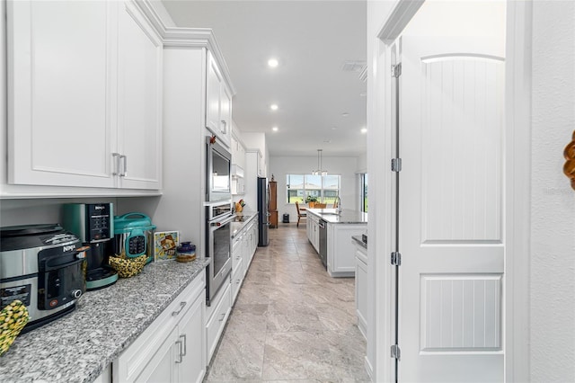 6046 SW 86th Cir, Ocala, FL 34481 - kitchen with appliances with stainless steel finishes, light stone counters, white cabinets, recessed lighting, and a sink
