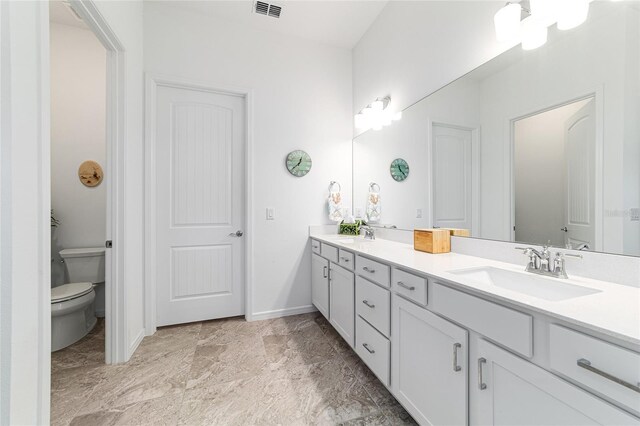 6046 SW 86th Cir, Ocala, FL 34481 - bathroom with double vanity, toilet, and baseboards