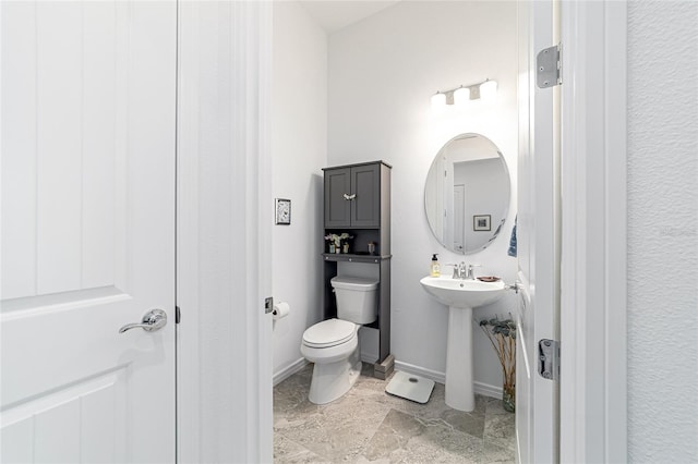 6046 SW 86th Cir, Ocala, FL 34481 - half bathroom featuring toilet, baseboards, and a sink