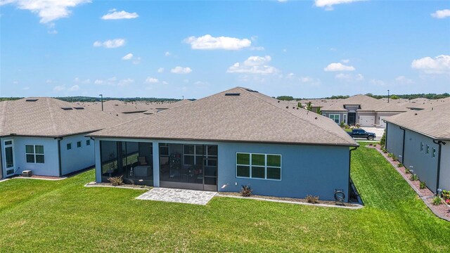 6046 SW 86th Cir, Ocala, FL 34481 - back of property featuring a sunroom, a lawn, a shingled roof, and stucco siding