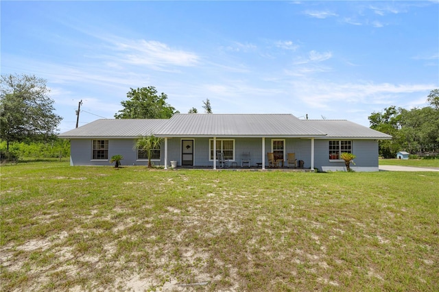 20818 SW 119th Ave, Archer, FL 32618 - view of front of home with a front yard, covered porch, and metal roof