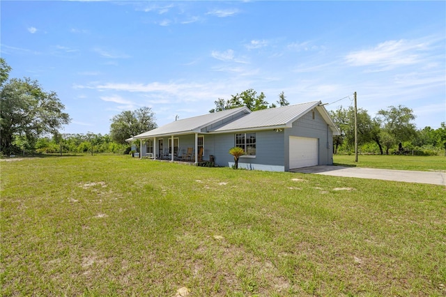 20818 SW 119th Ave, Archer, FL 32618 - view of front of home featuring an attached garage, driveway, a front lawn, and metal roof