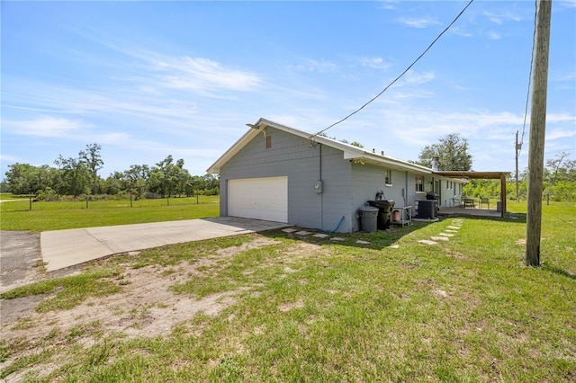 20818 SW 119th Ave, Archer, FL 32618 - view of side of home with driveway, a lawn, central AC unit, and an attached garage