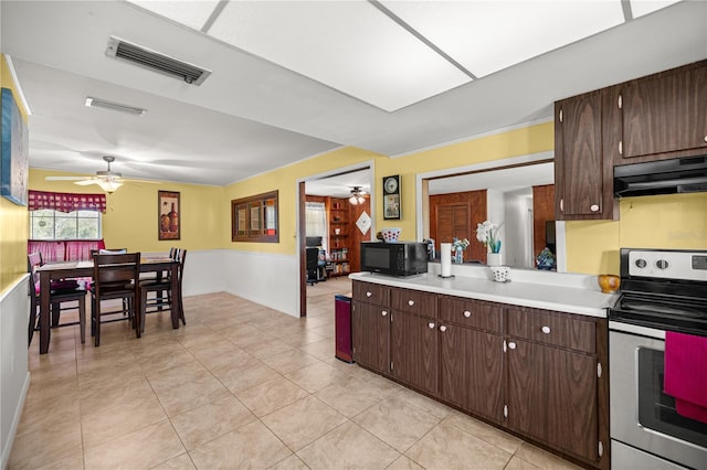 20818 SW 119th Ave, Archer, FL 32618 - kitchen featuring stainless steel electric range, ceiling fan, black microwave, under cabinet range hood, and light countertops