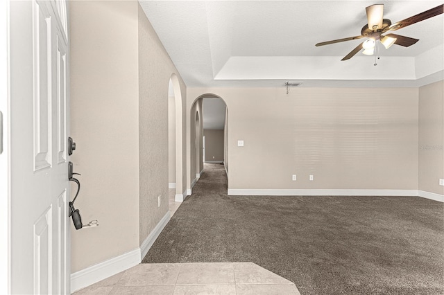 10313 SW 45th Ave, Ocala, FL 34476 - carpeted empty room featuring arched walkways, ceiling fan, baseboards, and a tray ceiling