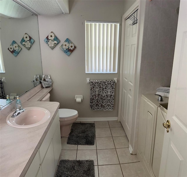 bathroom with tile patterned floors, vanity, and toilet