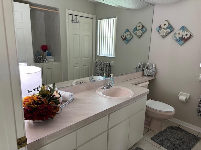 full bathroom with tile patterned flooring, toilet, vanity, and baseboards