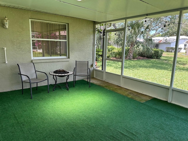 sunroom / solarium with a fire pit