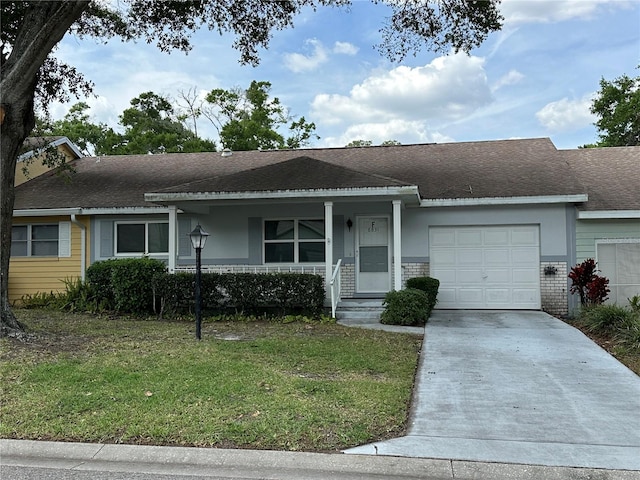 view of front of home featuring concrete driveway, a garage, a front lawn, roof with shingles, and brick siding