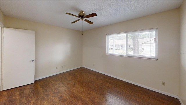 spare room with wood finished floors, ceiling fan, and baseboards