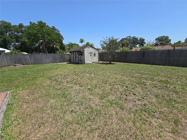 view of yard with a storage shed and an outbuilding