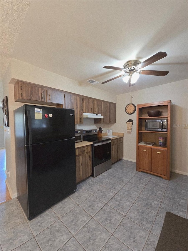 kitchen with stainless steel electric range, freestanding refrigerator, under cabinet range hood, a ceiling fan, and light countertops