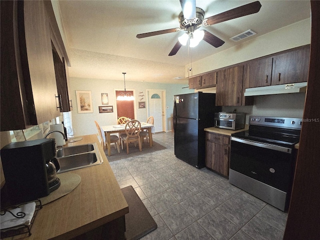 kitchen featuring stainless steel range with electric cooktop, freestanding refrigerator, a sink, under cabinet range hood, and ceiling fan