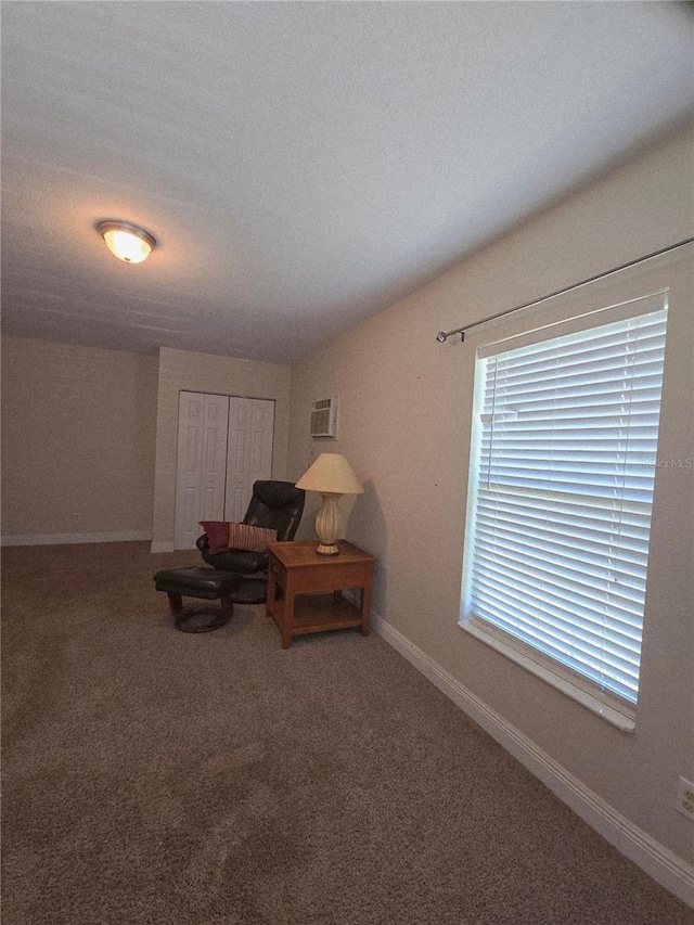 sitting room featuring baseboards and carpet flooring