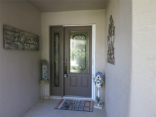 1799 W Shanelle Path, Lecanto, FL 34461 - doorway to property featuring stucco siding