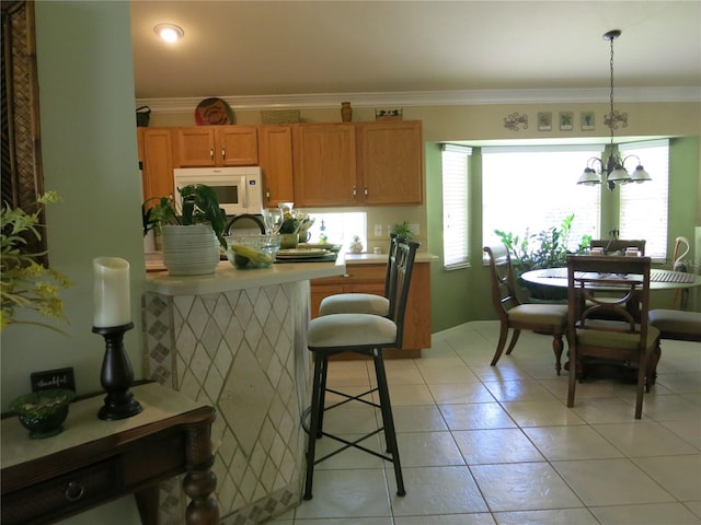 1799 W Shanelle Path, Lecanto, FL 34461 - kitchen featuring white microwave, light countertops, a chandelier, ornamental molding, and brown cabinetry
