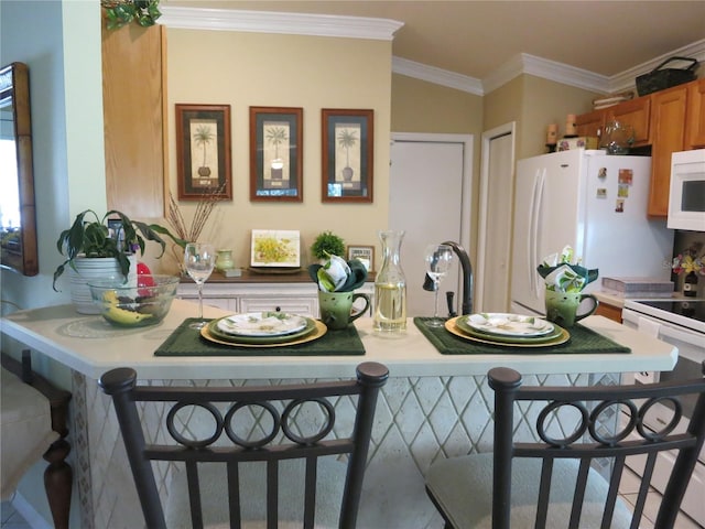 1799 W Shanelle Path, Lecanto, FL 34461 - kitchen with white appliances, brown cabinets, light countertops, crown molding, and a kitchen breakfast bar