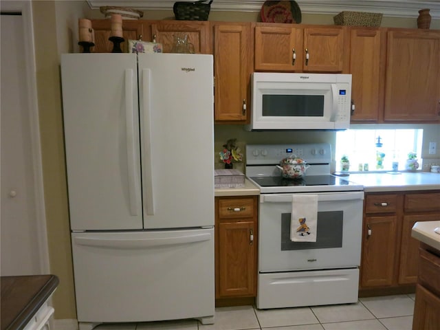 1799 W Shanelle Path, Lecanto, FL 34461 - kitchen featuring white appliances, light tile patterned flooring, light countertops, and brown cabinets