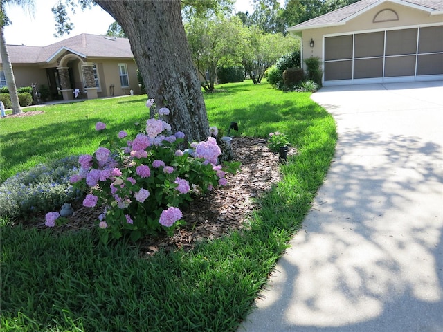 1799 W Shanelle Path, Lecanto, FL 34461 - view of grassy yard featuring concrete driveway and an attached garage