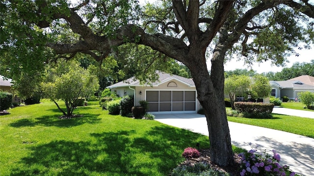 1799 W Shanelle Path, Lecanto, FL 34461 - view of front facade featuring a front yard, driveway, an attached garage, and stucco siding