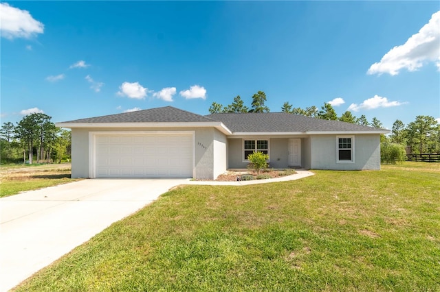 13561 SW 85th Pl, Dunnellon, FL 34432 - single story home with a garage, stucco siding, and driveway
