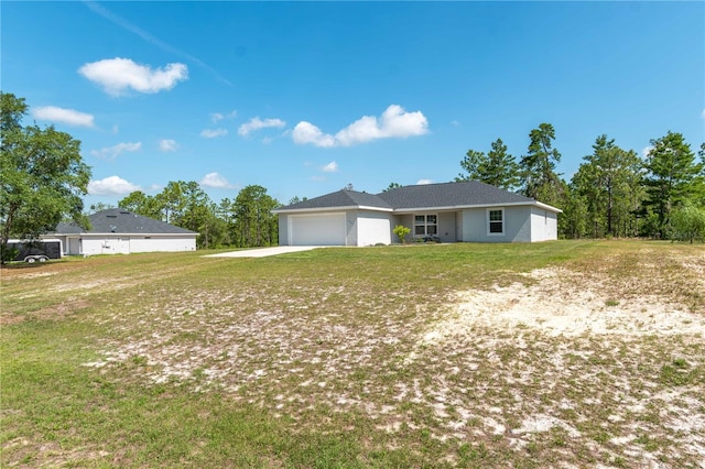 13561 SW 85th Pl, Dunnellon, FL 34432 - view of front of home featuring an attached garage, driveway, and a front lawn
