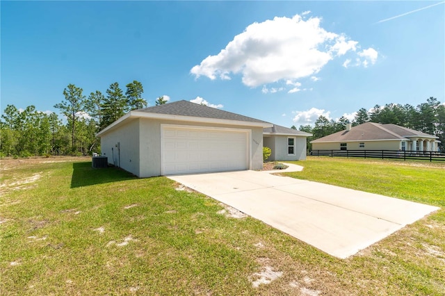 13561 SW 85th Pl, Dunnellon, FL 34432 - view of front of property featuring central AC, stucco siding, concrete driveway, and an attached garage