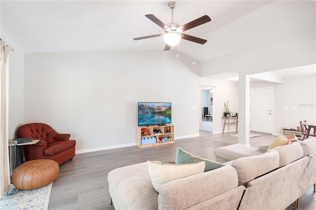 13561 SW 85th Pl, Dunnellon, FL 34432 - living room with a ceiling fan, vaulted ceiling, light wood-style flooring, and baseboards