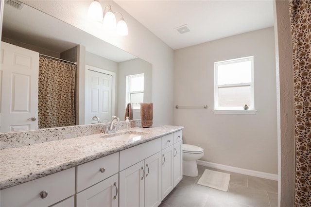 13561 SW 85th Pl, Dunnellon, FL 34432 - full bath with toilet, vanity, tile patterned flooring, and baseboards