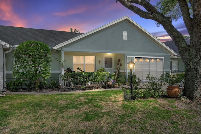 9661 SW 95th Ct Unit B, Ocala, FL 34481 - view of front of property featuring a lawn, stucco siding, and a garage