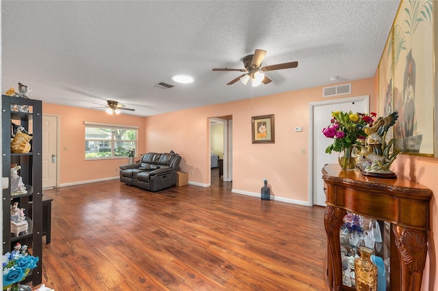9661 SW 95th Ct Unit B, Ocala, FL 34481 - living room featuring a ceiling fan, a textured ceiling, wood finished floors, and baseboards
