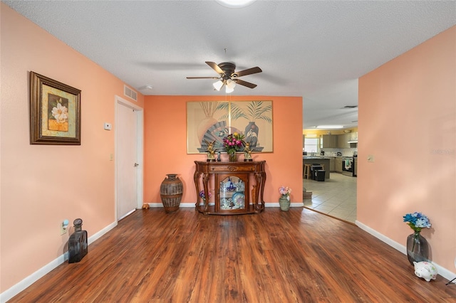 9661 SW 95th Ct Unit B, Ocala, FL 34481 - unfurnished living room featuring a ceiling fan, wood finished floors, and baseboards