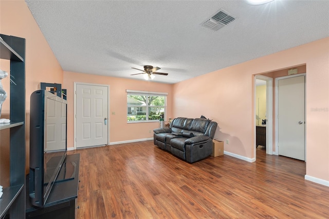 9661 SW 95th Ct Unit B, Ocala, FL 34481 - sitting room with a ceiling fan, a textured ceiling, wood finished floors, and baseboards