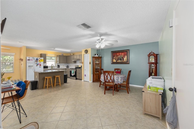 9661 SW 95th Ct Unit B, Ocala, FL 34481 - dining area with ceiling fan, a textured ceiling, and baseboards