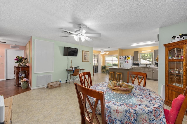 9661 SW 95th Ct Unit B, Ocala, FL 34481 - dining area with ceiling fan, a textured ceiling, and light tile patterned flooring