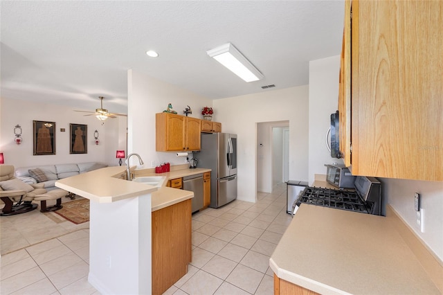 9663 SW 92nd Place Rd, Ocala, FL 34481 - kitchen featuring stainless steel appliances, open floor plan, a peninsula, a sink, and light countertops
