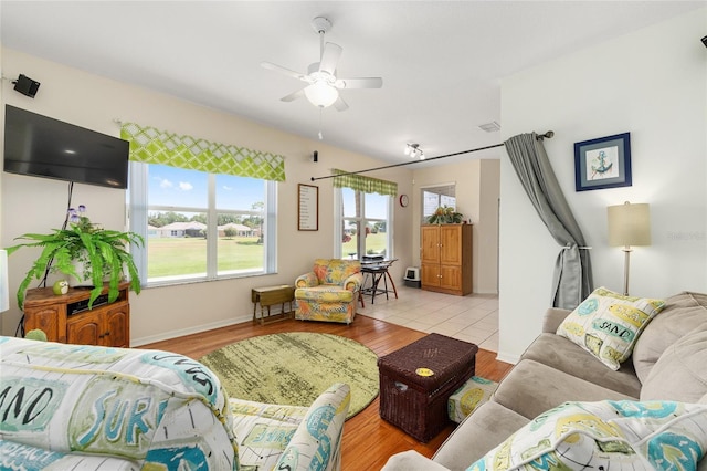 9663 SW 92nd Place Rd, Ocala, FL 34481 - living room with healthy amount of natural light, a ceiling fan, and light wood-style flooring