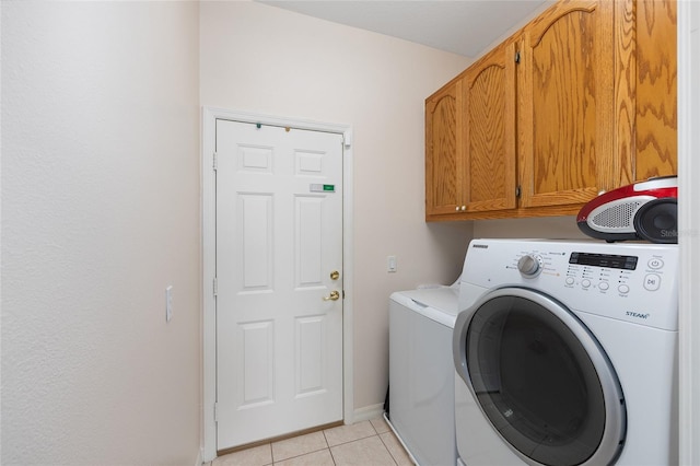 9663 SW 92nd Place Rd, Ocala, FL 34481 - washroom with cabinet space, separate washer and dryer, light tile patterned floors, and baseboards