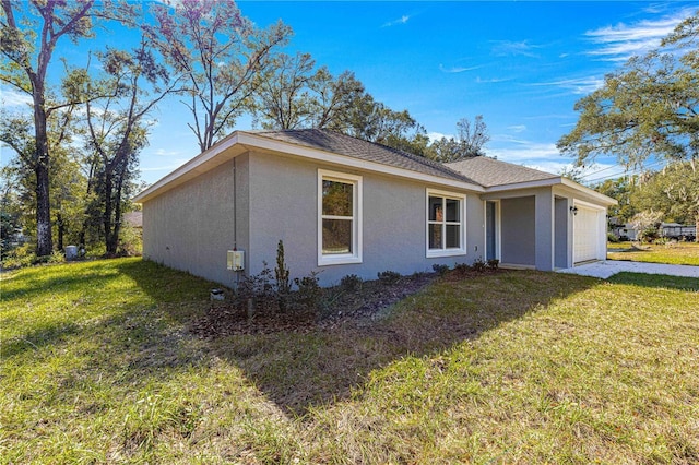 view of home's exterior with a garage, stucco siding, and a lawn