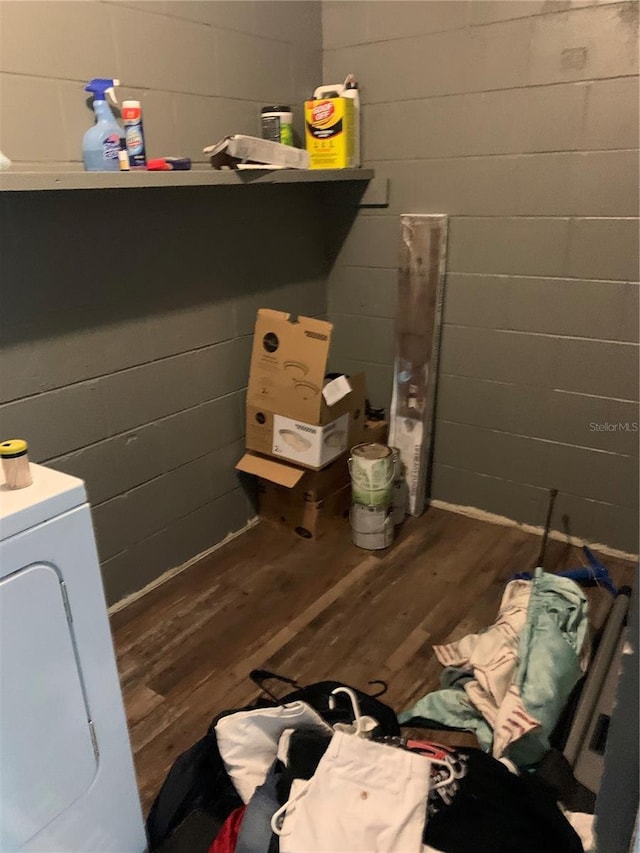 1912 NE 50th St, Ocala, FL 34479 - laundry room featuring wood finished floors, washer / clothes dryer, and concrete block wall