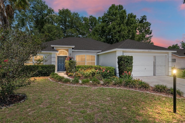8053 SW 62nd Ave, Ocala, FL 34476 - ranch-style home featuring a garage, driveway, a lawn, and stucco siding