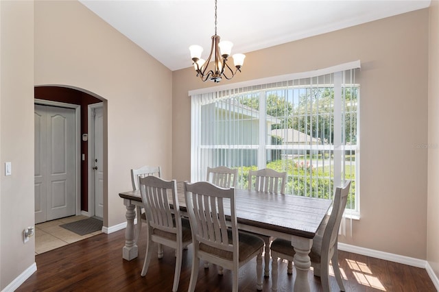 8053 SW 62nd Ave, Ocala, FL 34476 - dining area with arched walkways, a chandelier, baseboards, and wood finished floors