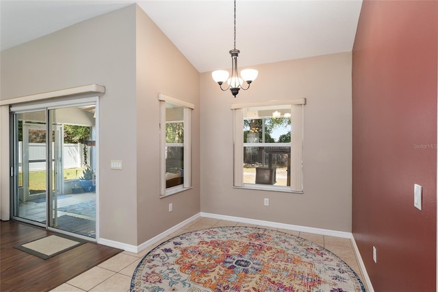 8053 SW 62nd Ave, Ocala, FL 34476 - dining area featuring plenty of natural light, lofted ceiling, baseboards, tile patterned floors, and a chandelier