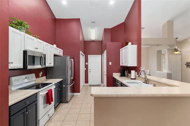 8053 SW 62nd Ave, Ocala, FL 34476 - kitchen with stainless steel appliances, a sink, a towering ceiling, white cabinets, and light countertops