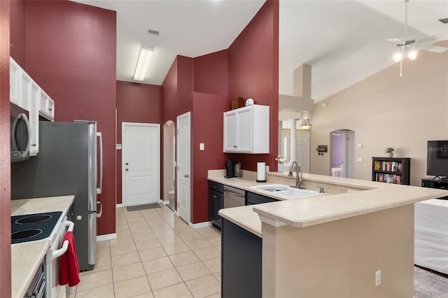 8053 SW 62nd Ave, Ocala, FL 34476 - kitchen featuring a sink, white range with electric stovetop, stainless steel microwave, high vaulted ceiling, and arched walkways
