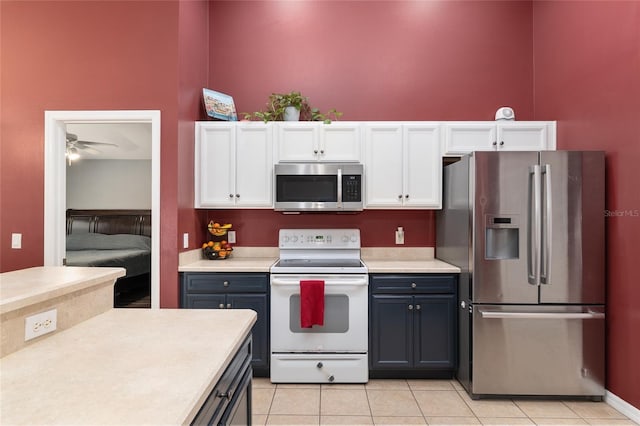 8053 SW 62nd Ave, Ocala, FL 34476 - kitchen with appliances with stainless steel finishes, white cabinetry, light countertops, and light tile patterned floors