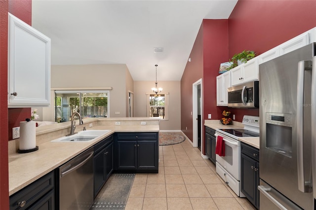 8053 SW 62nd Ave, Ocala, FL 34476 - kitchen with appliances with stainless steel finishes, a sink, white cabinetry, light countertops, and lofted ceiling