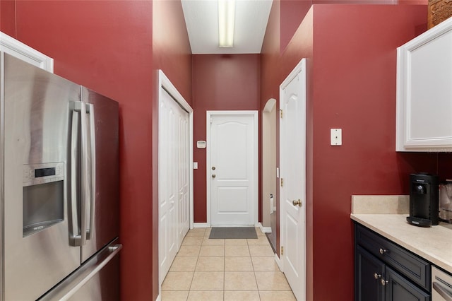 8053 SW 62nd Ave, Ocala, FL 34476 - kitchen featuring stainless steel fridge with ice dispenser, light countertops, light tile patterned floors, and baseboards