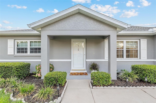 9729 SW 97th St, Ocala, FL 34481 - doorway to property with stucco siding and a shingled roof